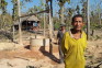 Village man in front of cement well